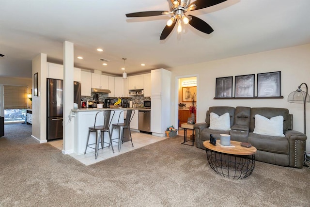 carpeted living room featuring ceiling fan