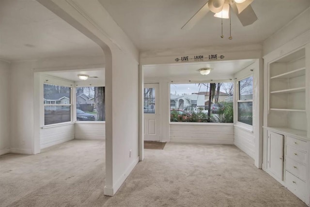 interior space featuring ceiling fan and built in shelves