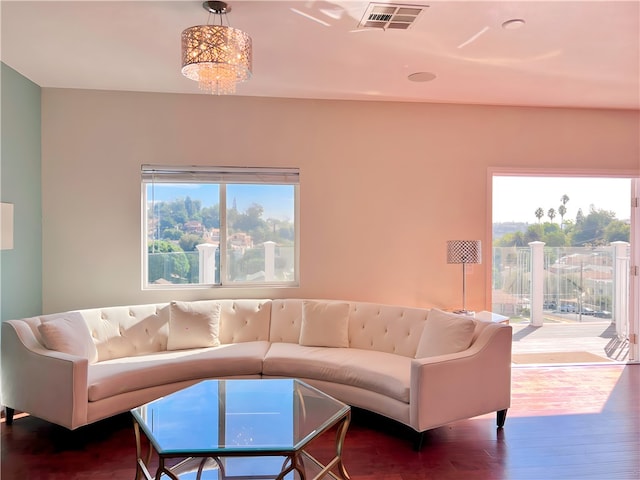 living room with an inviting chandelier and hardwood / wood-style flooring