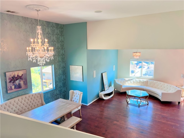 living room featuring dark hardwood / wood-style flooring and a chandelier