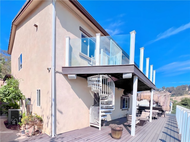 back of property with central AC and a wooden deck