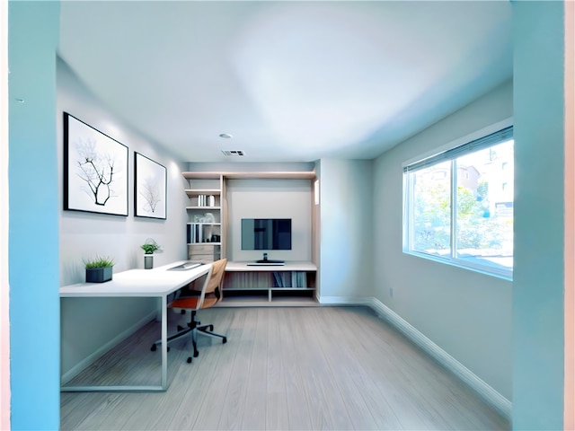 home office with hardwood / wood-style flooring