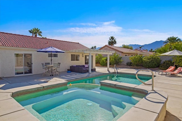 view of swimming pool featuring a pergola, an in ground hot tub, a mountain view, and a patio