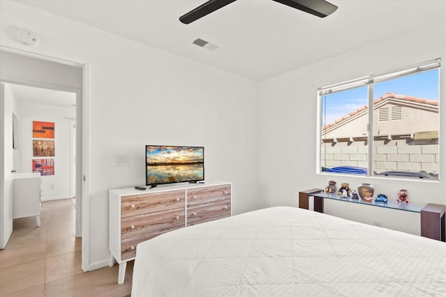 bedroom with ceiling fan and light tile patterned floors