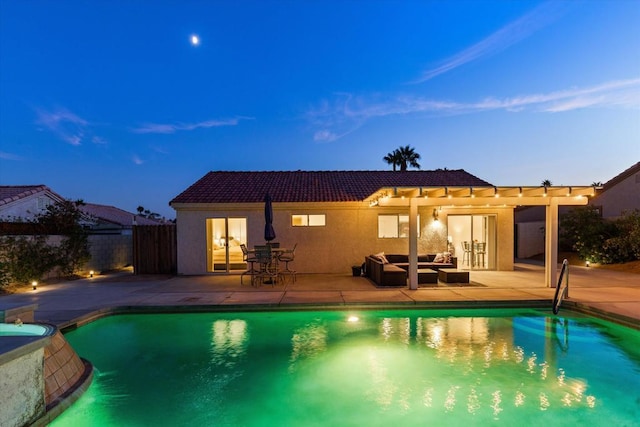 pool at dusk featuring an outdoor hangout area and a patio