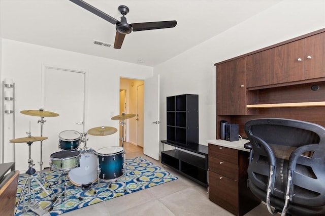 tiled home office featuring ceiling fan