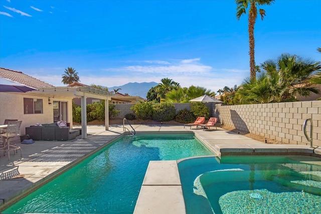 view of swimming pool featuring a mountain view, a patio, an in ground hot tub, and an outdoor living space