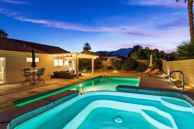 pool at dusk with a pergola and a patio