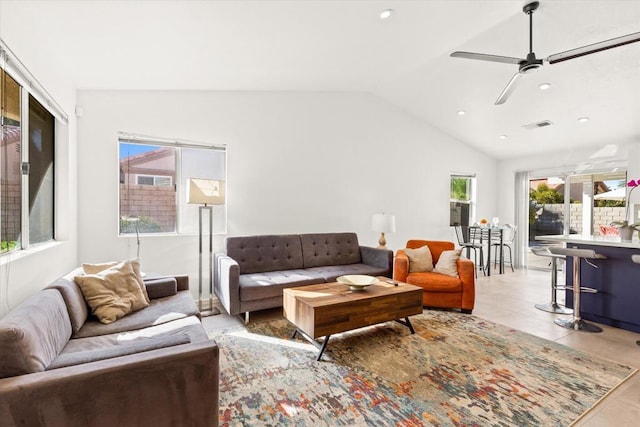 living room with light tile patterned floors, ceiling fan, and lofted ceiling