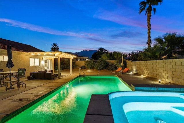 pool at dusk featuring a patio