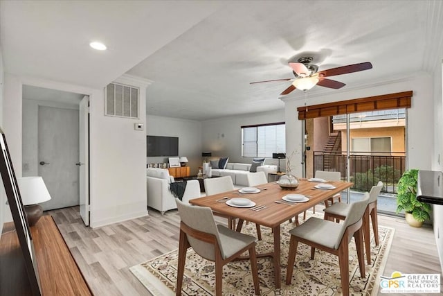 dining room featuring light hardwood / wood-style floors, a wealth of natural light, ornamental molding, and ceiling fan