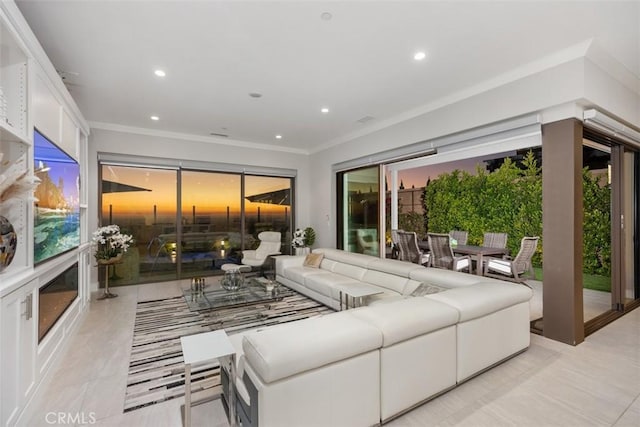 living room featuring plenty of natural light, ornamental molding, and light tile patterned floors