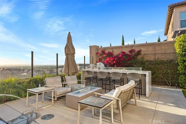 view of patio with a bar and an outdoor fire pit