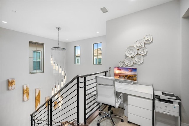 home office with a chandelier