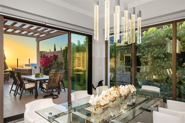 sunroom / solarium featuring an inviting chandelier