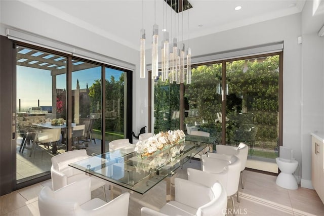 dining space featuring plenty of natural light, light tile patterned floors, and a chandelier