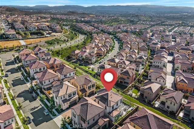 birds eye view of property with a mountain view