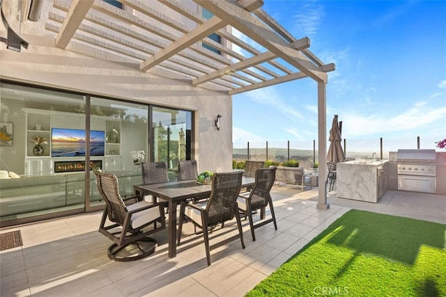 view of patio / terrace featuring a pergola, grilling area, and exterior kitchen