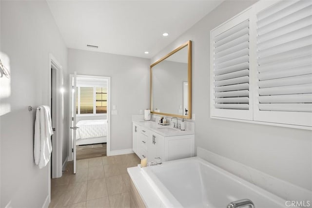 bathroom featuring tile patterned flooring, vanity, and a bathtub