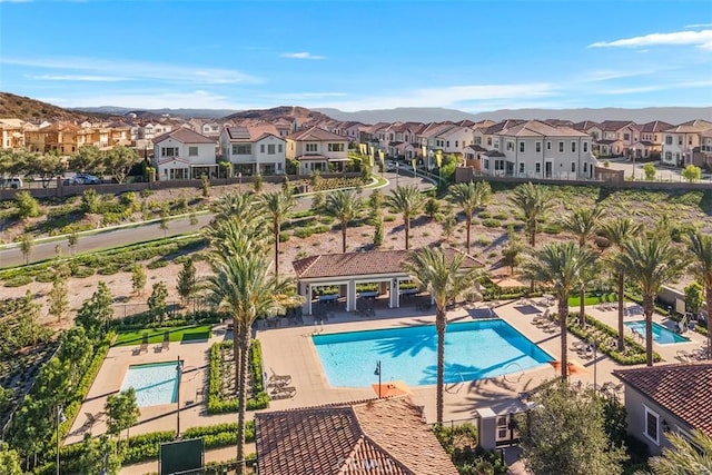 view of swimming pool with a mountain view and a patio area