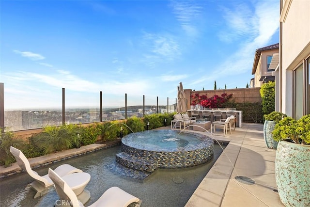 view of patio / terrace featuring pool water feature and an in ground hot tub