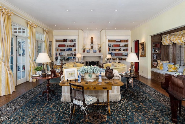 living area with crown molding, dark hardwood / wood-style flooring, and built in features