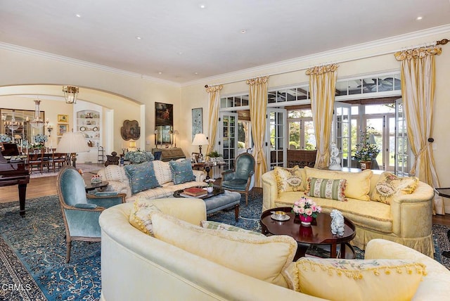 living room with wood-type flooring, ornamental molding, and french doors