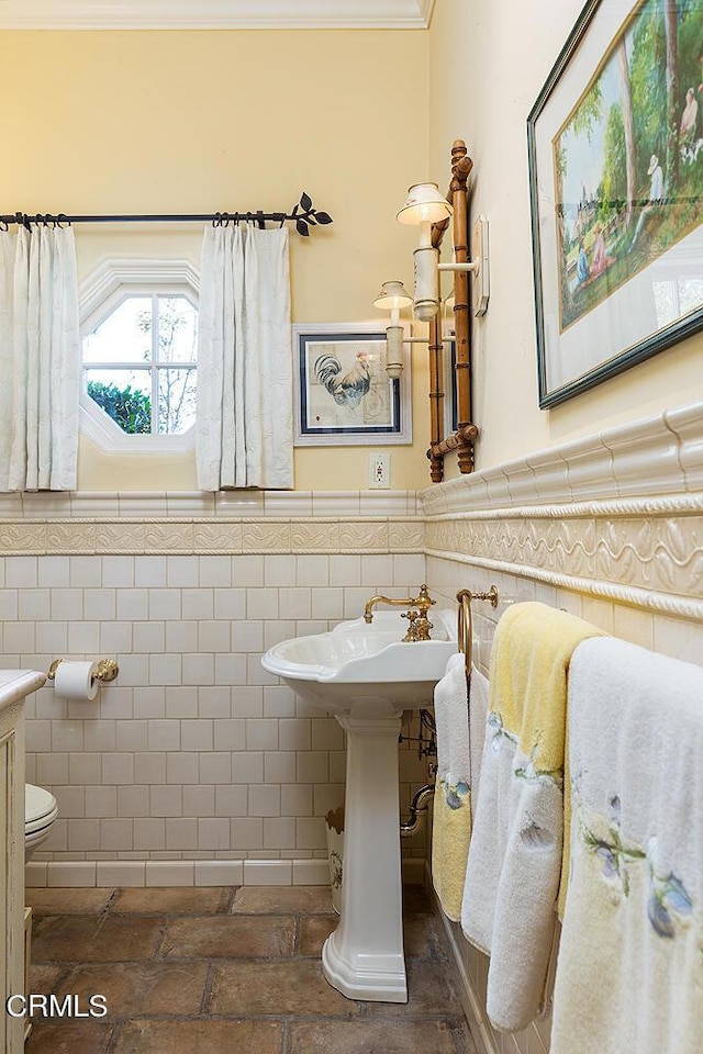 bathroom featuring tile patterned flooring, vanity, walk in shower, and tile walls