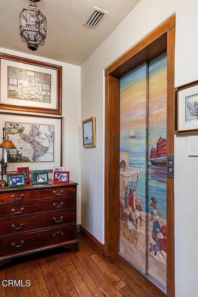 hallway with dark hardwood / wood-style flooring