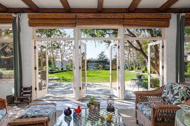 doorway featuring beamed ceiling, french doors, and a wealth of natural light