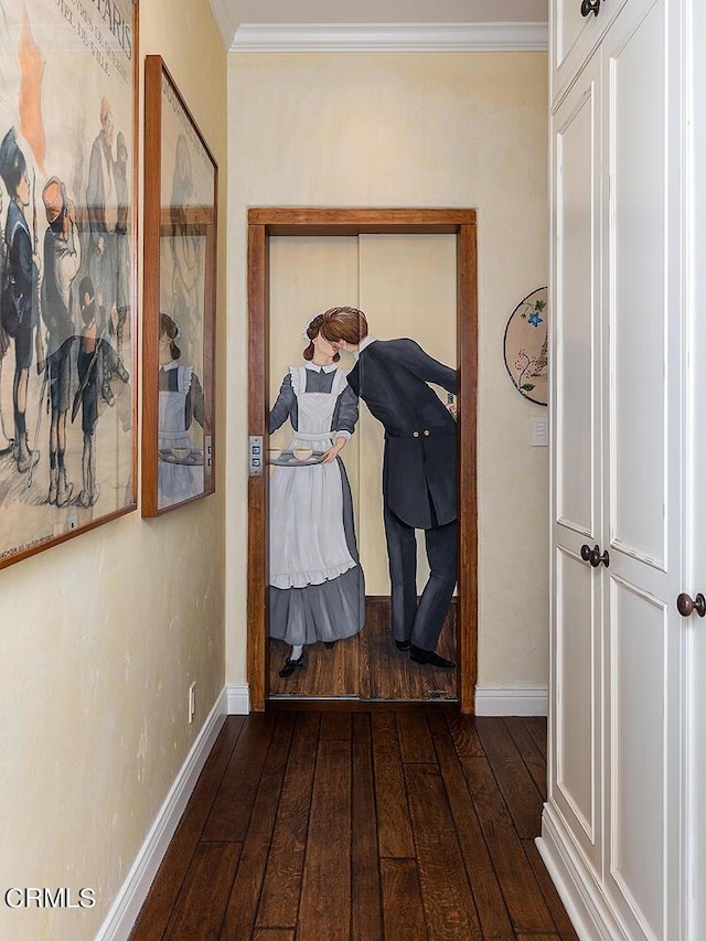 corridor featuring dark hardwood / wood-style floors and crown molding