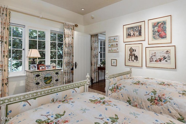 unfurnished bedroom with wood-type flooring and multiple windows