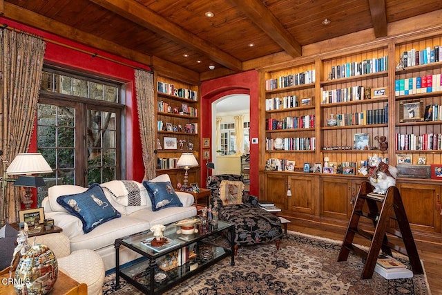 sitting room with beamed ceiling, wood-type flooring, built in features, and wooden ceiling