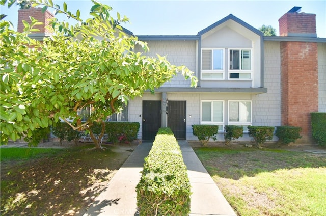 view of property featuring a front lawn