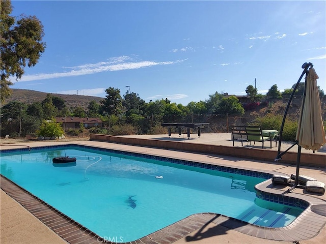 view of pool with a mountain view, a patio, and a pergola