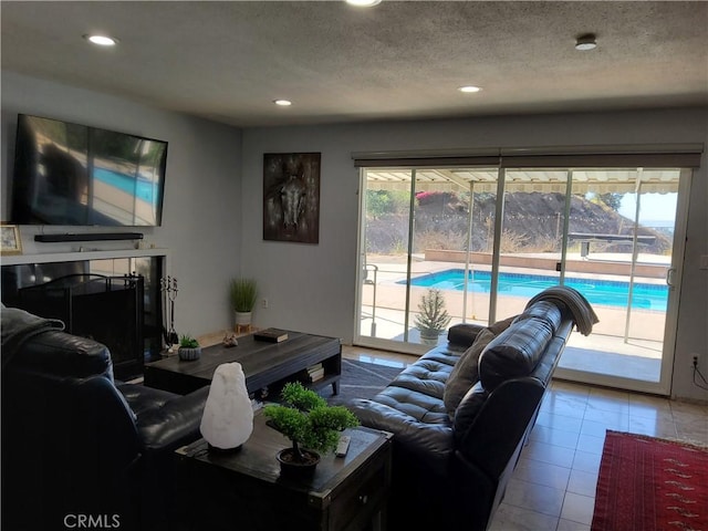 tiled living room with a wealth of natural light and a textured ceiling