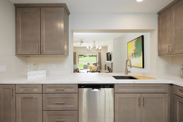 kitchen featuring sink, stainless steel dishwasher, a chandelier, and backsplash