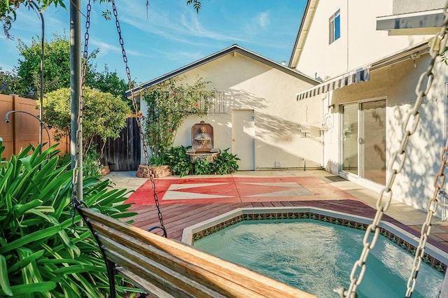 view of swimming pool featuring an outdoor hot tub and a deck