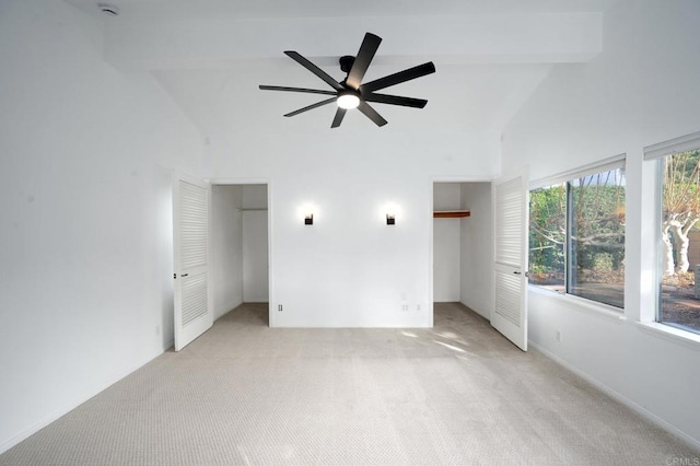 empty room with lofted ceiling with beams, light carpet, and ceiling fan