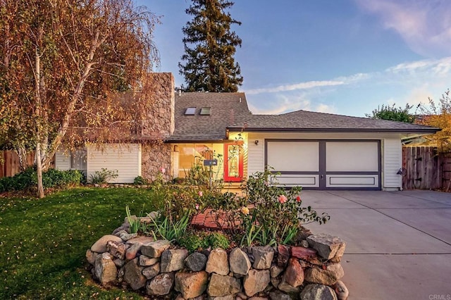 view of front of house with a garage and a front lawn