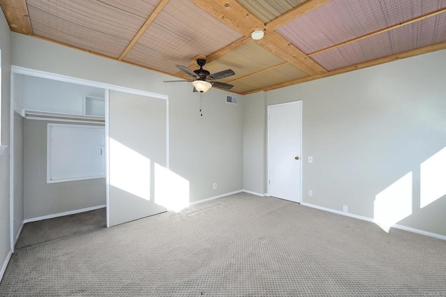 unfurnished bedroom with ceiling fan, carpet floors, and a closet