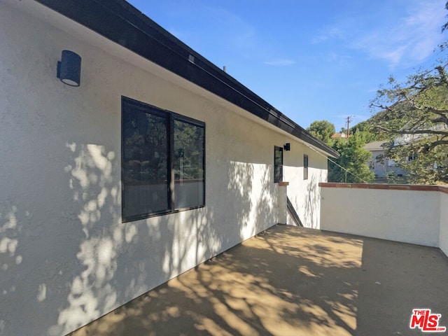 view of property exterior featuring a patio