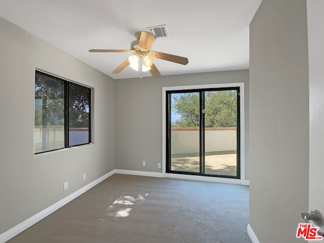 empty room with ceiling fan and carpet