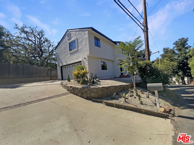 view of side of home featuring a garage