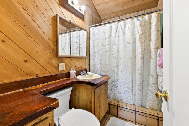 bathroom with vanity, curtained shower, wooden walls, and toilet