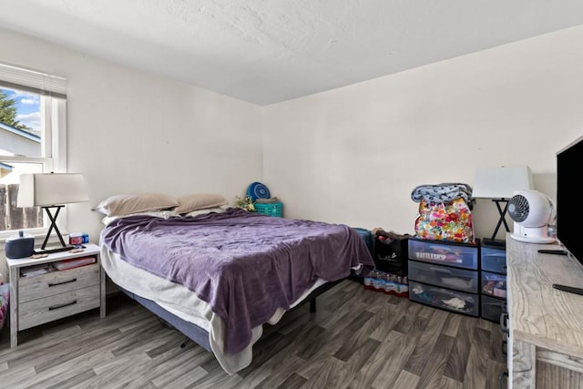 bedroom featuring dark hardwood / wood-style flooring and billiards