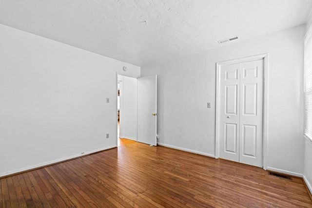 unfurnished bedroom with wood-type flooring