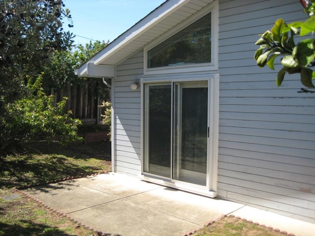 view of side of property with a patio area