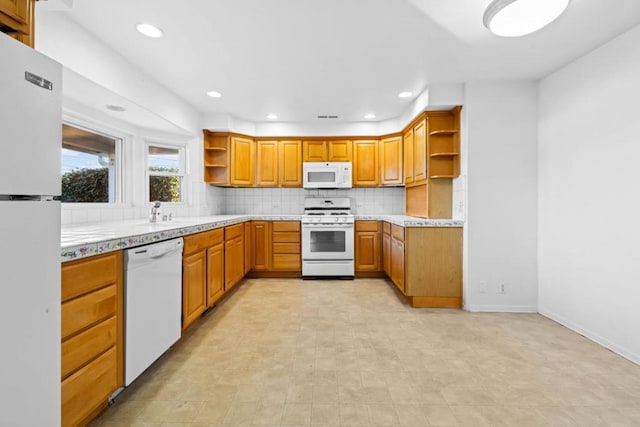 kitchen with tasteful backsplash and white appliances