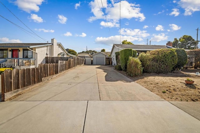 view of front of house featuring a garage and an outbuilding